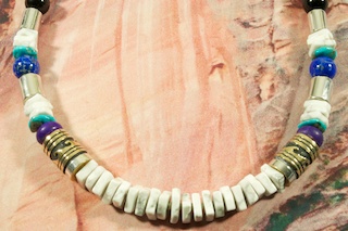 Assorted Genuine Gemstones Necklace with Sterling Silver and Gold fill Barrels. Featuring Genuine Howlite with Turquoise, Sugilite, Blue Lapis and Black Onyx  Accents. Sterling Silver Beads, Cones and Clasp.  Created by Navajo Artist Tommy Singer